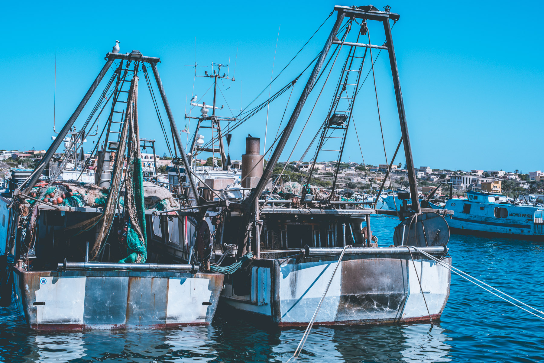 viwe from the front of two boats in tha harbour of the island of Lampedusa