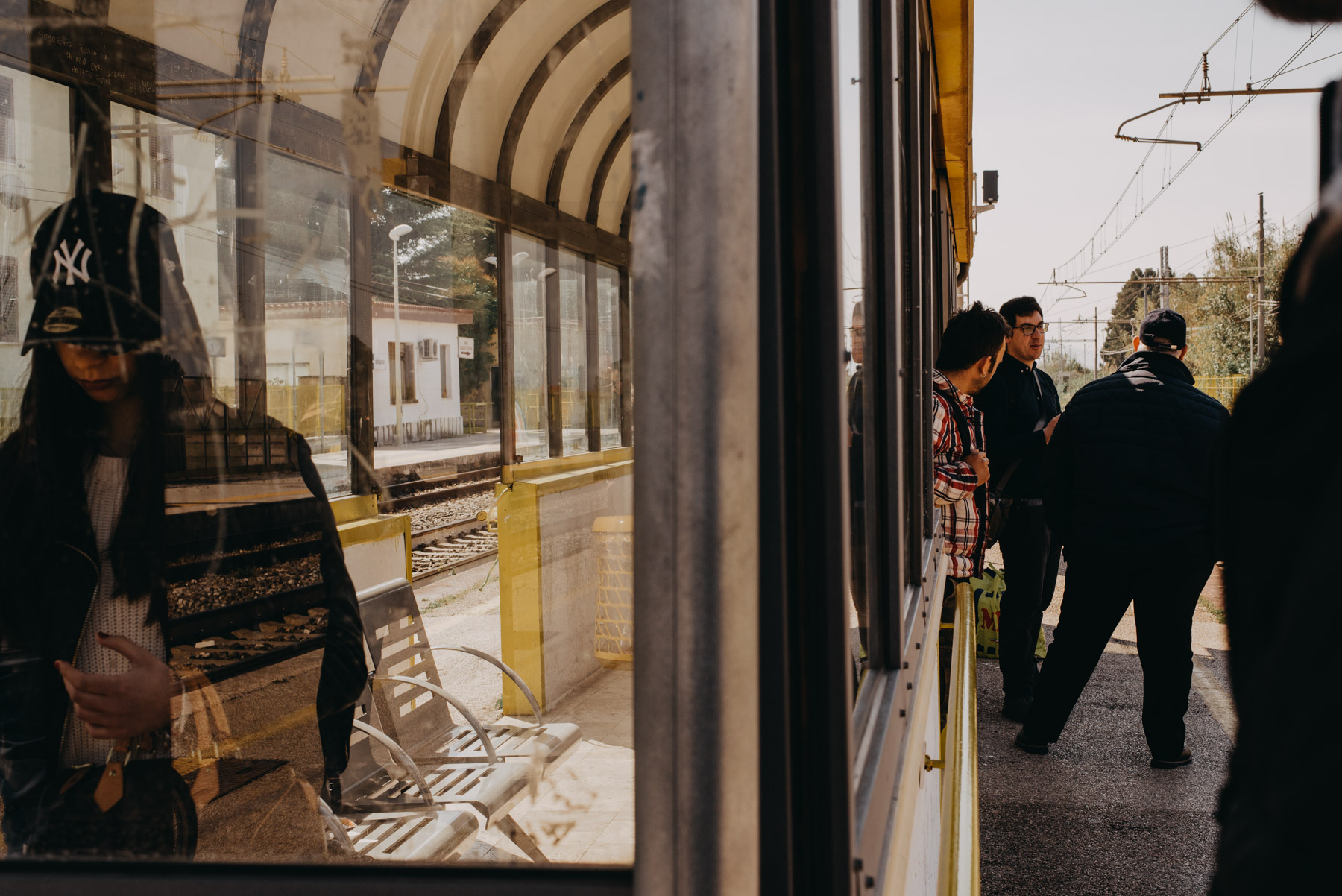 street photography scene in the city of Capaccio Salerno, showing people in the railway station waiting for the train