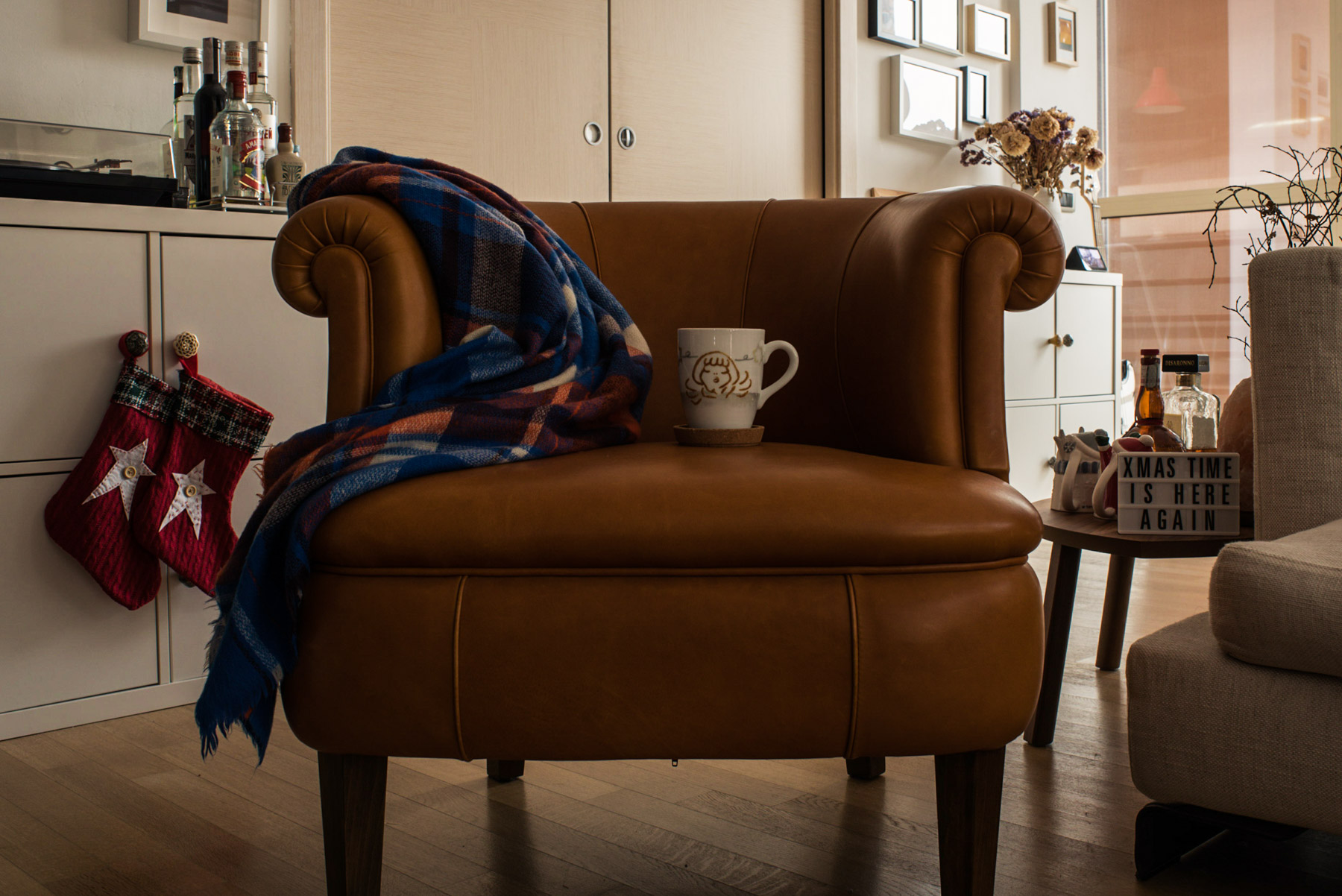 A sofa, a blanket and a mug during Christmas